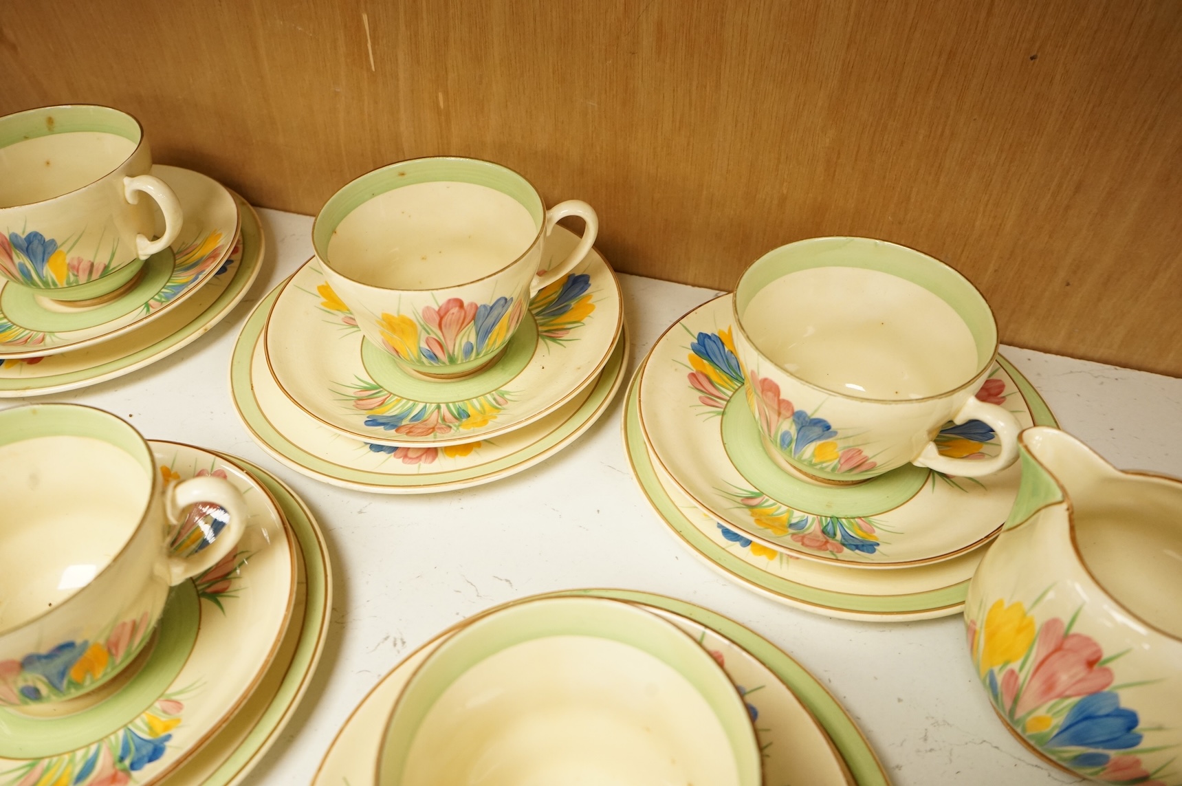 Collection of Clarice Cliff crocus pattern tea wares to include trios, milk jug, and a bowl, largest 22cm in diameter